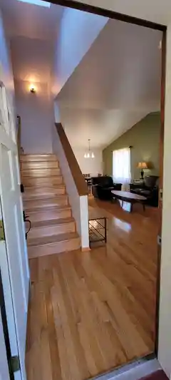 Entry hall with shoe rack beside stairs