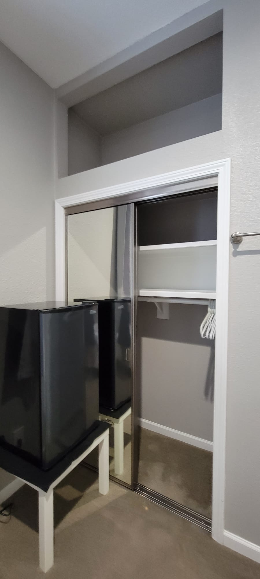 Mini fridge in the room and wardrobe