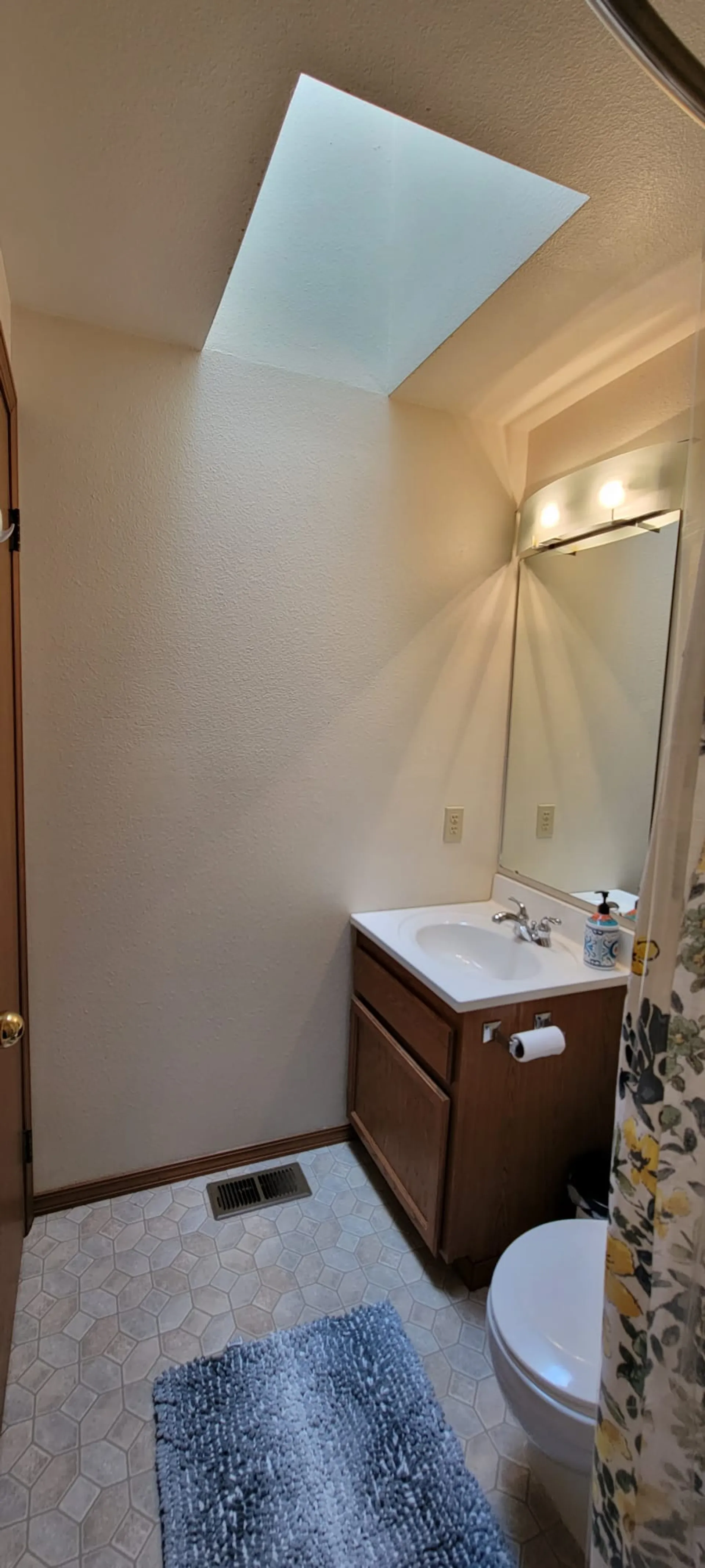 Upper floor bathroom sink and mirror